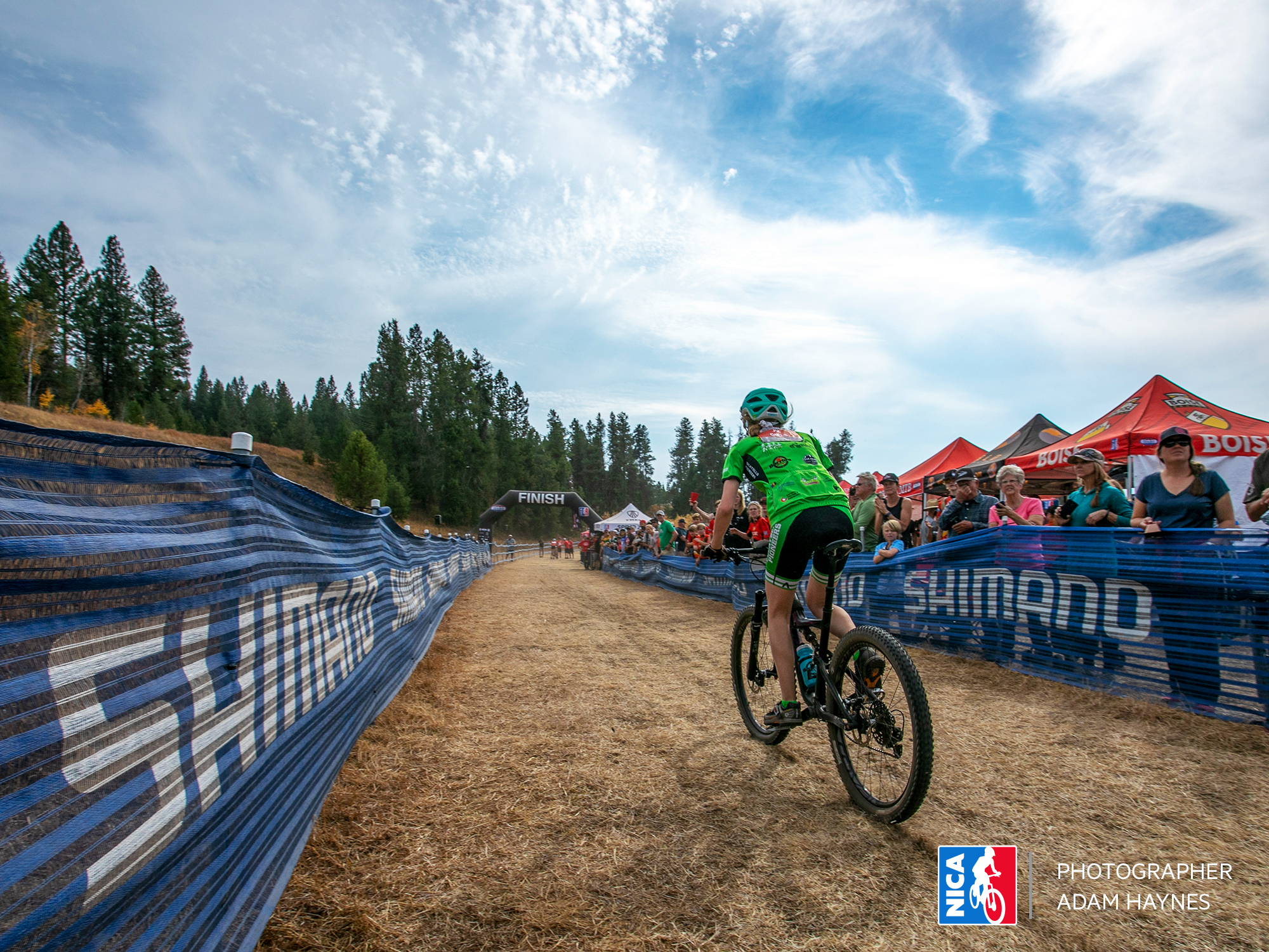 coming down tot he finish line at a NICA high School Mountain Bike Race