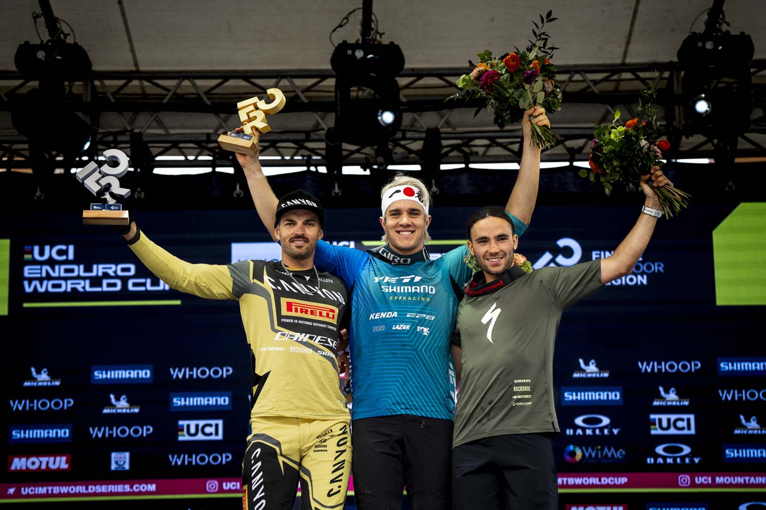 Shimano Yeti Ep Racing athlete Ryan Gilchrist standing on the top of the podium 