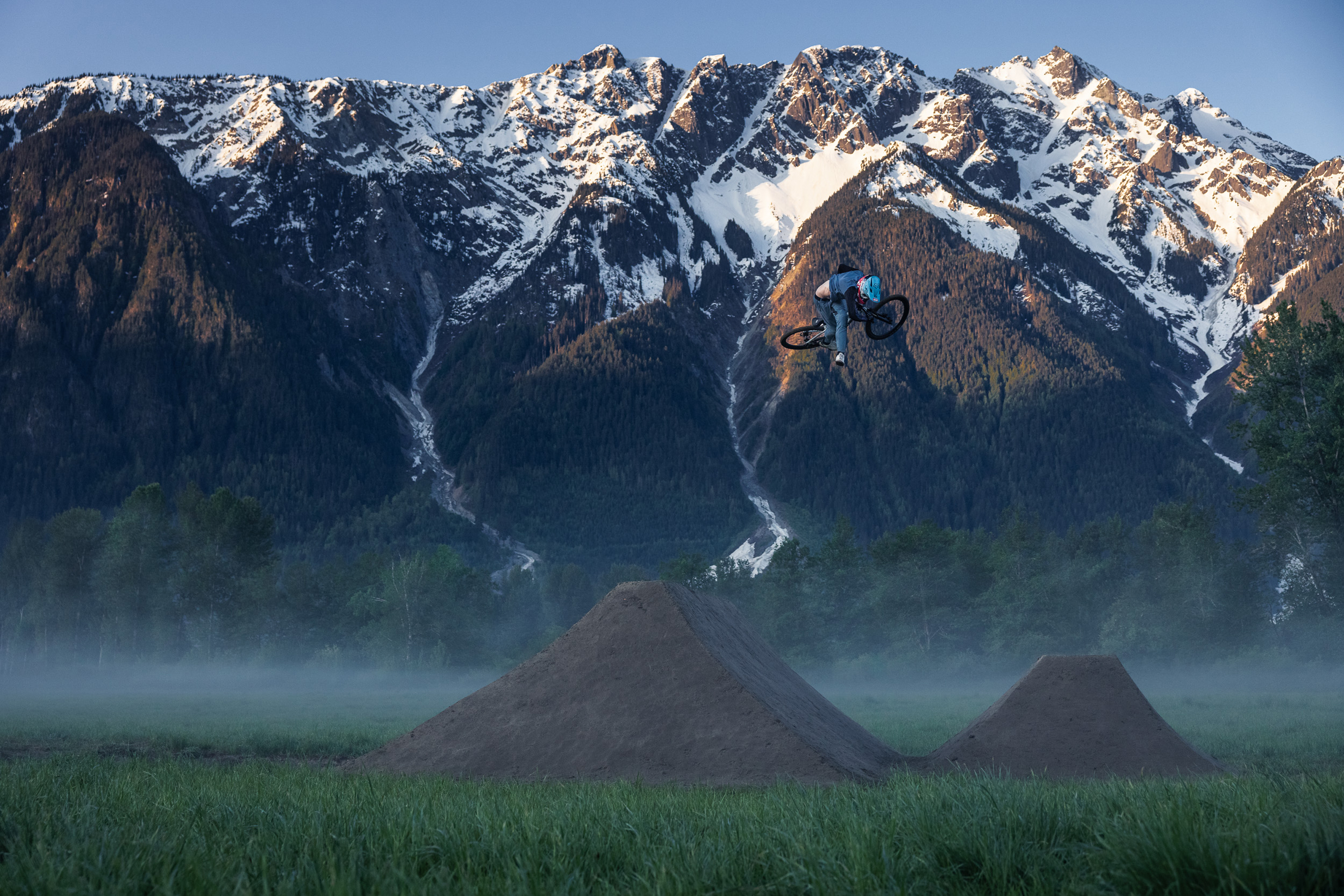 Snow capped mountains and dirt jumps