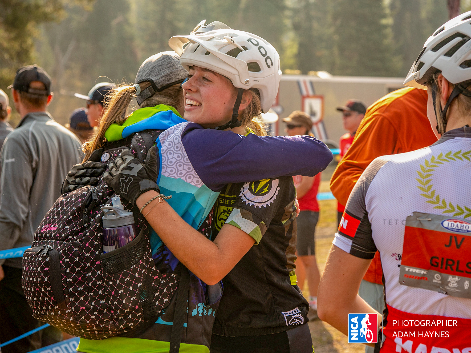 embracing her coach after a hard fought mountain bike race