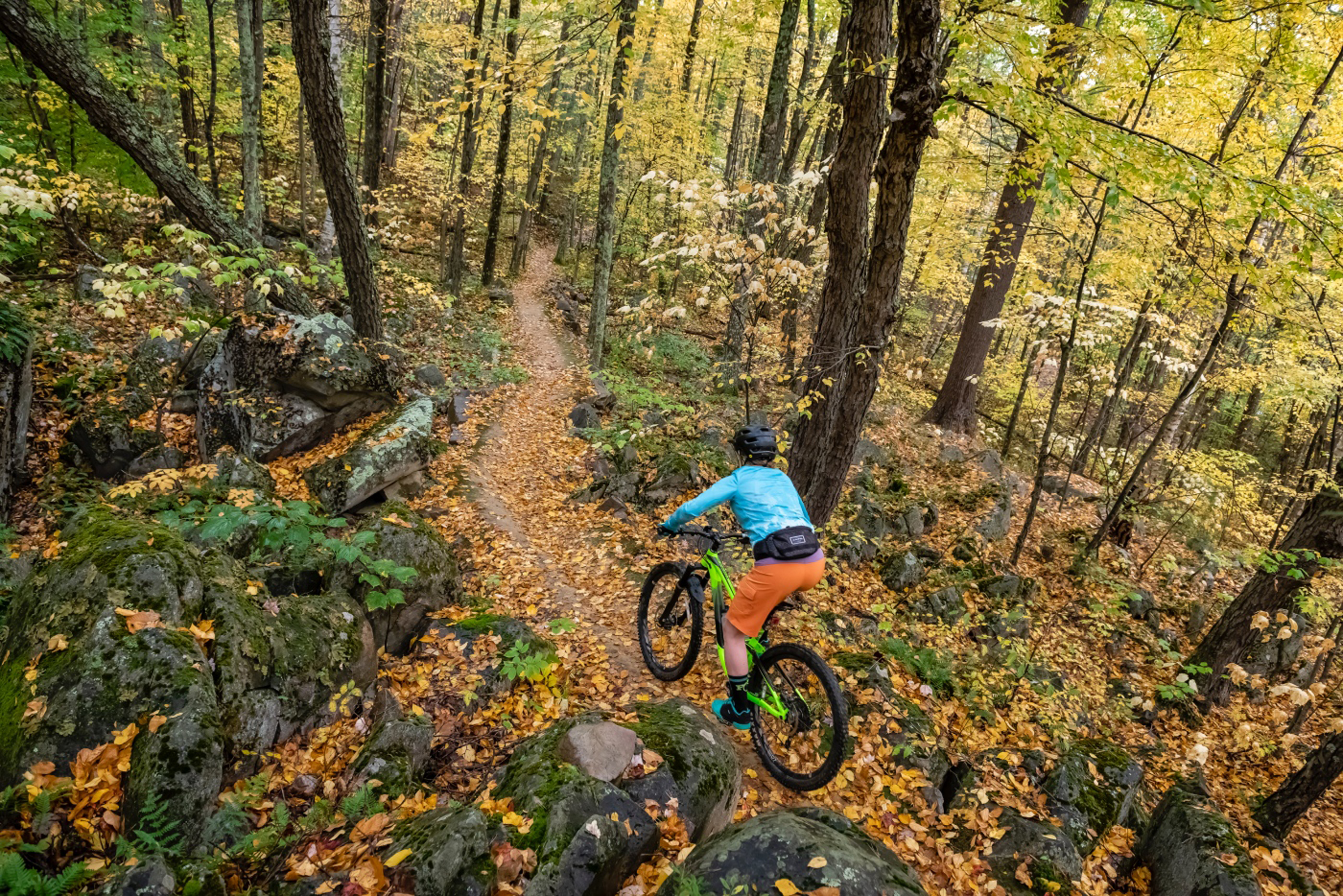 Women trail riding a mountain bike